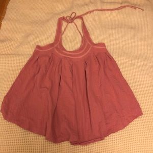 Free People swing top. New w/tags. Color is a muted pink. Pretty string detail.